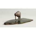 A SMALL CAST SILVER MODEL OF A KIWI, on a jadeite plinth. Kiwi: 4cms long.