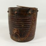 AN EARLY TURNED WOOD PAIL, with wrought iron mounts. 27cms high x 26cms diameter.