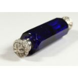 A VICTORIAN BRISTOL BLUE GLASS FACET CUT DOUBLE ENDED SCENT BOTTLE with repousse silver caps.