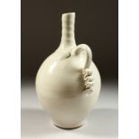 A STUDIO POTTERY BOTTLE, with ribbed neck, moulded handle and incised decoration. 26cms high.