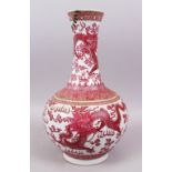 A CHINESE 19TH CENTURY CARMINE RED PORCELAIN DRAGON BOTTLE VASE, the body wwith intertwined