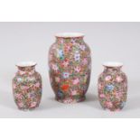 A GARNITURE OF THREE CHINESE EGGSHELL PORCELAIN FAMILLE ROSE VASES, with millefleur style