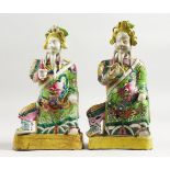 A GOOD PAIR OF 18TH CENTURY CHINESE FAMILLE ROSE FIGURES of seated Gods. 9ins high.