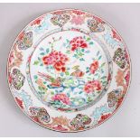 A GOOD 18TH CENTURY CHINESE FAMILLE ROSE PORCELAIN PLATE, decorated with scenes of birds amongst