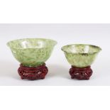 A GOOD PAIR OF 20TH CENTURY CHINESE GREEN JADE / HARDSTONE BOWLS, with accompanying carved stands,