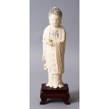 A GOOD 19TH CENTURY CHINESE CARVED IVORY FIGURE OF BUDDHA, stood upon a hardwood stand, holding a