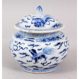 A 19TH CENTURY CHINESE BLUE & WHITE JAR AND COVER, decorated with scenes of lion dogs amongst