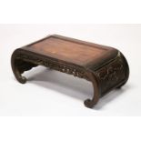 A 19TH CENTURY CHINESE HARDWOOD / PADOUK COFFEE / OPIUM TABLE, feet of scrolling form, the apron