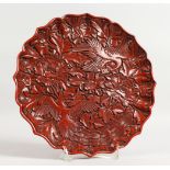 A GOOD CHINESE CINNABAR LACQUER CARVED CIRCULAR DISH with birds and flowers. 10ins diameter.