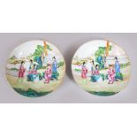 A PAIR OF 18TH CENTURY CHINESE FAMILLE ROSE PORCELAIN SAUCERS, decorated with figures in landscapes,