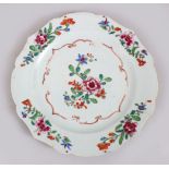 A GOOD 18TH CENTURY CHINESE FAMILLE ROSE PORCELAIN PLATE, decorated with scenes of flora, 22.5cm