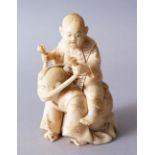 A GOOD JAPANESE MEIJI PERIOD CARVED IVORY OKIMONO OF KARAKO / ACTORS, the actor on his knees