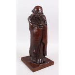 A GOOD 19TH CENTURY NATURALISTIC HARDWOOD CARVED FIGURE OF SHOU LOU, stood enclosed in his robes,