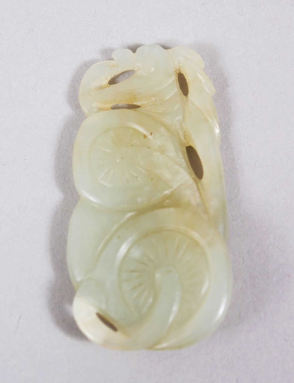 A GOOD 18TH / 19TH CENTURY CHINESE WHITE JADE PENDANT OF MUSHROOMS, 5.4cm wide X 2.5cm deep.