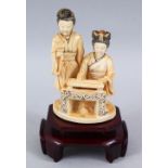 A 19TH CENTURY CHINESE CARVED IVORY FIGURE OF TWO LADIES, two ladies seated at a low table, one