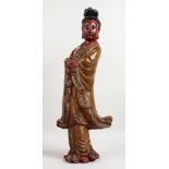 A SUPERB 18TH CENTURY CHINESE CARVED WOOD FIGURE OF GUANYIN standing with arms crossed. 23ins high.