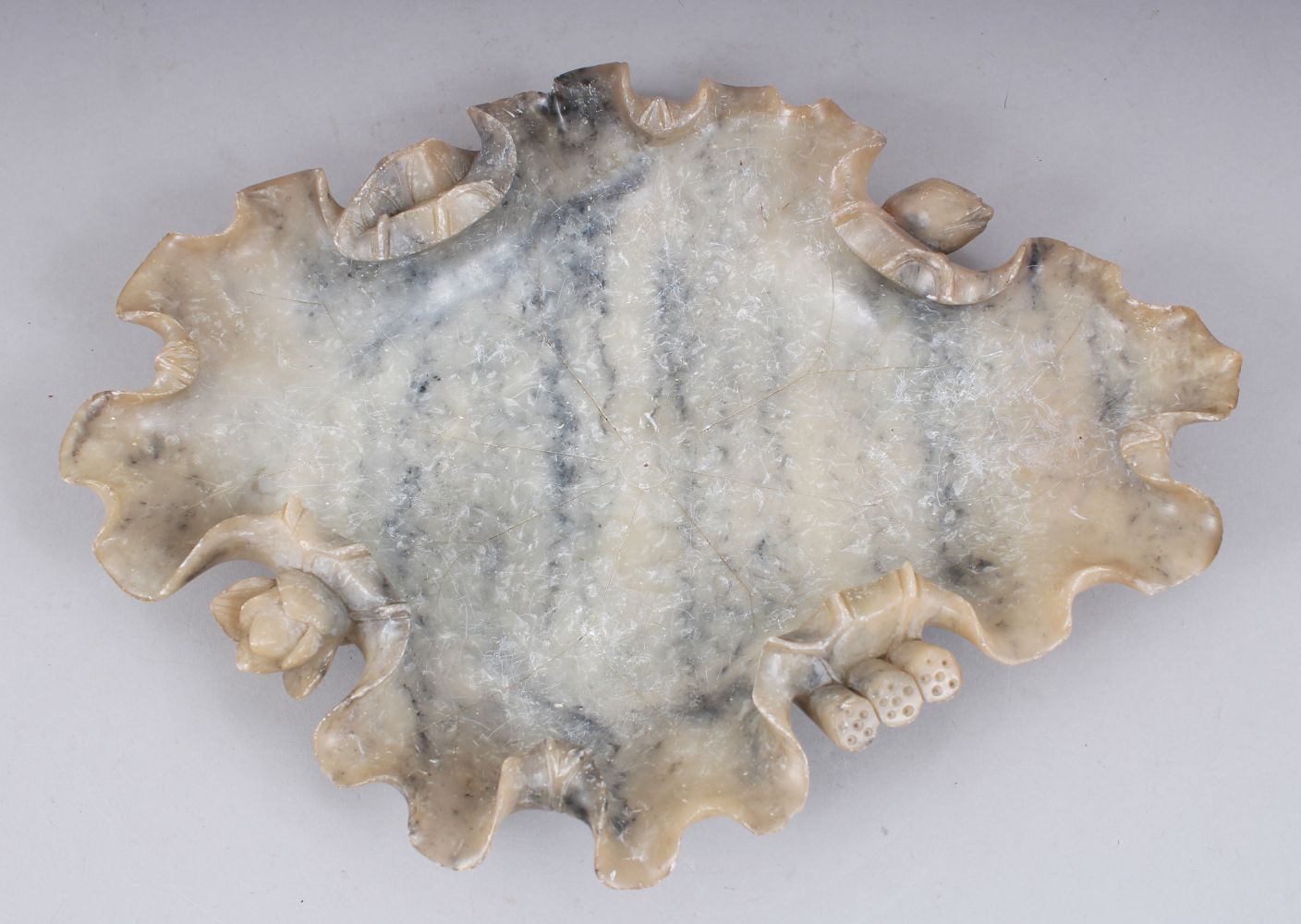 A GOOD LARGE 19TH / 20TH CENTURY CHINESE JADE BRUSH REST / DISH, carved in lotus leaf form with