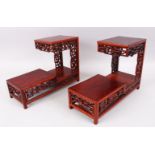 A PAIR OF LATE 19TH / 20TH CENTURY CHINESE CARVED HARDWOOD TWO TIER STANDS, with carved and