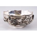 A LARGE JAPANESE MEIJI PERIOD SOLID SILVER DRAGON BOWL, the bowl decorated in relief to depict a