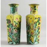 A GOOD PAIR OF 19TH CENTURY CHINESE FAMILLE JAUNE SQUARE TAPERING VASES painted with panels of