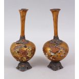 A PAIR OF JAPANESE MEIJI PERIOD GOLD LACQUER, SHIBAYAMA & ENAMEL BOTTLE VASES, the vases with a gold