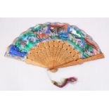 A 19TH CENTURY CANTON CARVED SANDALWOOD & PAINTED PAPER FAN, the carved stems depicting in relief