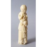 A 19TH CENTURY CHINESE CARVED IVORY FIGURE OF A BOY, stood holding a display of ikebana / floral