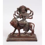 A GOOD INDIAN BRONZE FIGURE OF A BUDDHA / GODDESS - DURGA ON LION, seated upon the back of a lion,