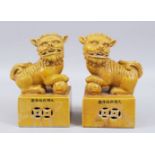 A GOOD PAIR OF CHINESE BISCUIT GROUND PORCELAIN FIGURES OF LION DOGS, the opposing pair in