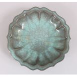 A GOOD CHINESE SCALLOPED RU WARE CRACKLE GLAZED PORCELAIN DISH, the cracked ice glaze with green /