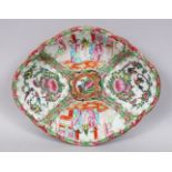 A 19TH CENTURY CHINESE CANTON FAMILLE ROSE PORCELAIN DISH, decorated with panels of figures and