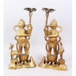 A GOOD PAIR OF LATE 19TH CENTURY CHINESE BRONZE CANDLESTICKS - BOYS WITH CRANE AND DEER, the