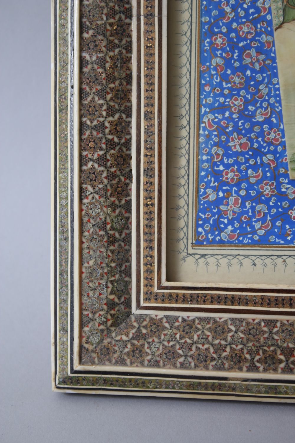 A PERSIAN PAINTING ON IVORY, tents, figures on camels and cows, 10cm x 20cm in a mosaic frame. - Image 3 of 3
