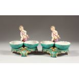 A PAIR OF BERLIN DOUBLE BASKET SALTS, each with a cupid and two oval bowls with young lovers.