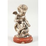 A SILVERED CAST METAL MODEL OF CUPID RIDING ON A DOLPHIN, on a marble base. 5ins high overall.