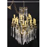 A GOOD CUT GLASS AND SILVERED METAL TWO-TIER CHANDELIER, comprising fifteen scrolling arms, each