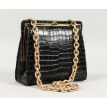 A BLACK CROCODILE-SKIN BAG with chain handle.