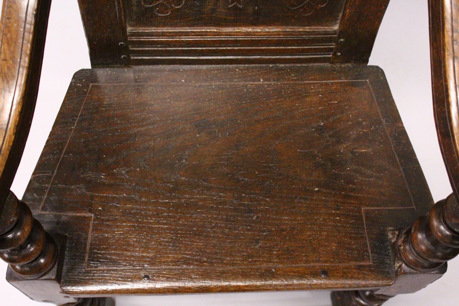 AN 18TH CENTURY OAK WAINSCOT ARMCHAIR, with carved back, solid seat and curving arms and turned - Image 7 of 11