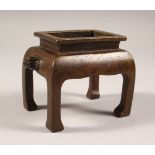 A SMALL RECTANGULAR BRONZE CENSER ON CURVING LEGS. 5.5ins wide.