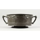 A LIBERTY & CO ENGLISH PEWTER CIRCULAR TWO-HANDLED ROSE BOWL, No. 011, the sides with "AND THE