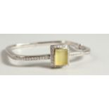 AN 18CT WHITE GOLD DIAMOND SET BANGLE, with large lemon quartz stone.