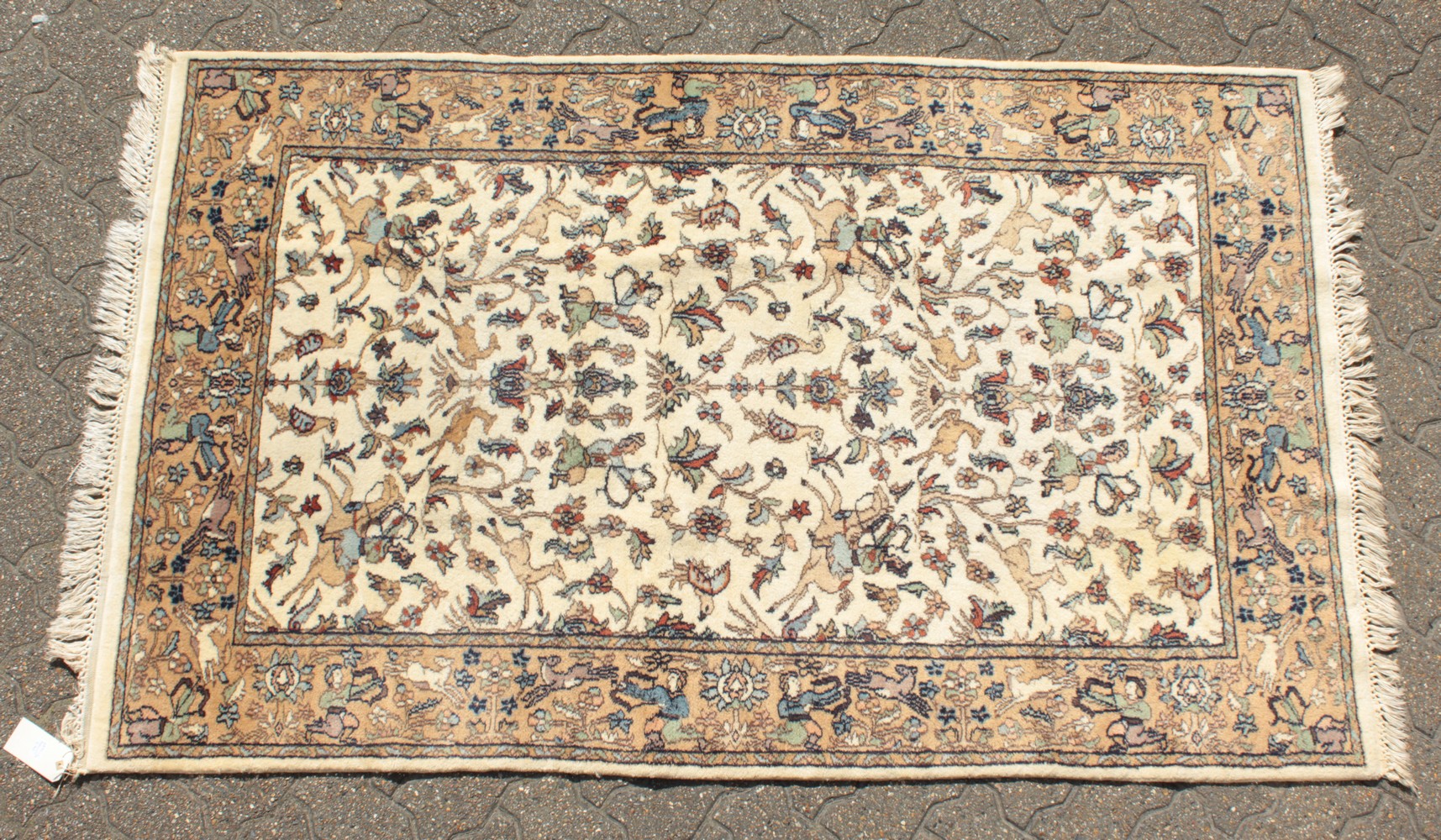 A GOOD INDIAN WOOL RUG with hunting scenes on a white background. 6ft 4ins x 4ft.