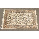 A GOOD INDIAN WOOL RUG with hunting scenes on a white background. 6ft 4ins x 4ft.