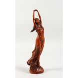 AN ART NOUVEAU STYLE CARVED WOOD FIGURE OF A YOUNG GIRL. 9ins high.