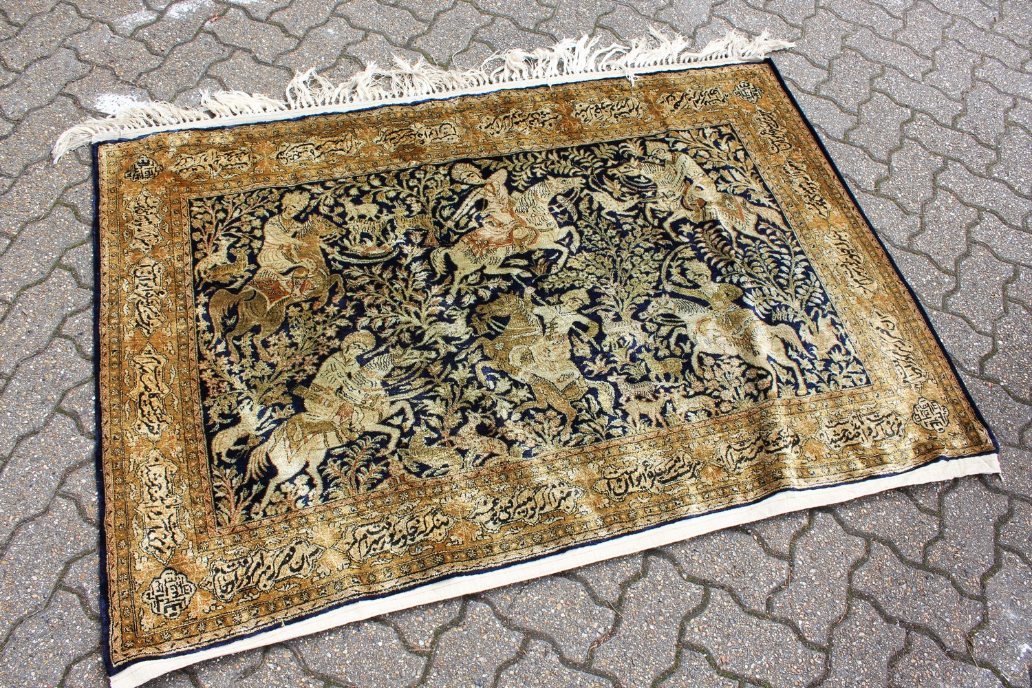 AN EASTERN PART SILK HANGING, the central panel decorated with a hunting scene with figures on