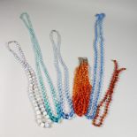 SEVEN VARIOUS GLASS BEAD NECKLACES.