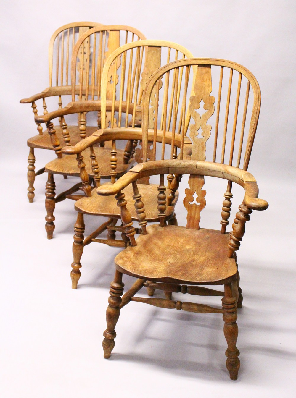 A GOOD SET OF FOUR 19TH CENTURY OAK WINDSOR HIGH BACK ARMCHAIRS.