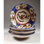 A SET OF FOUR ISLAMIC POTTERY BOWLS, each painted with stylised birds. 9.5ins diameter.