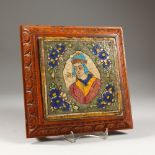 AN ISLAMIC POTTERY TILE, painted with a bust within a floral border, mounted in a later carved