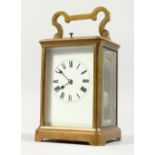 A GOOD FRENCH BRASS CARRIAGE CLOCK, with repeat movement, white enamel dial and Roman numerals. 5.